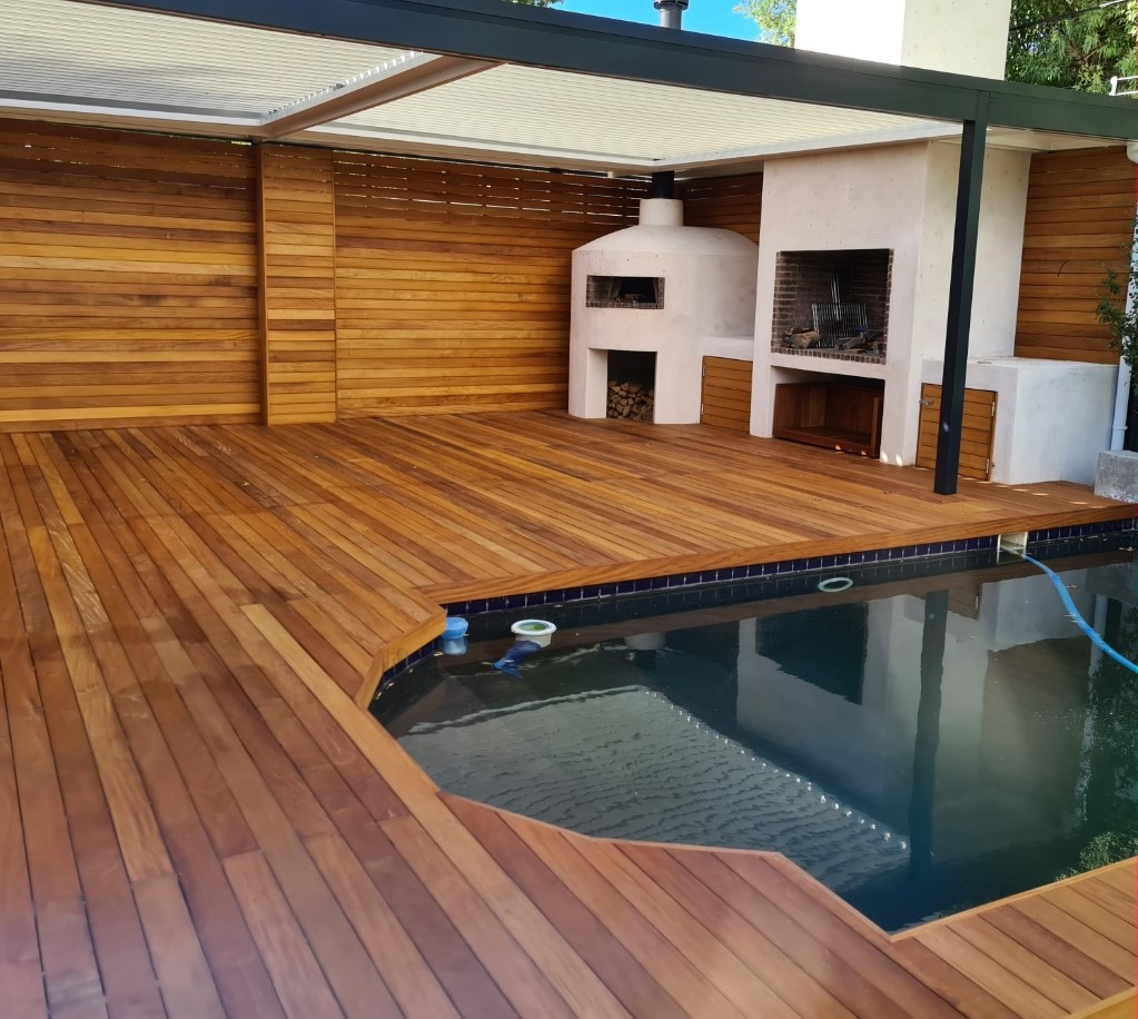 Luxury outdoor kitchen and pizza oven built into a custom Garapa deck by Cape Town Timber Decking in Bishopscourt.